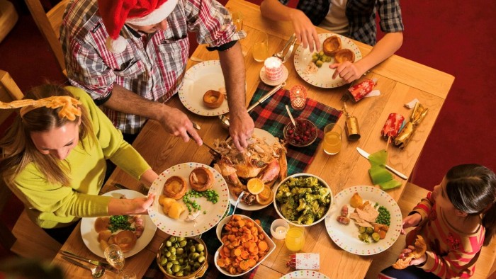 A family tuck in to a traditional Christmas dinner