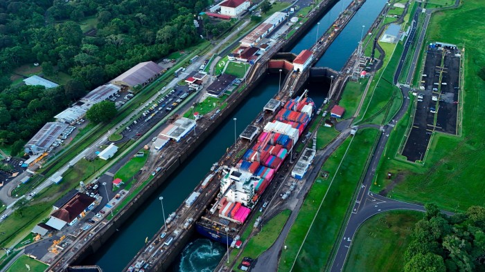 Aerial view of a cargo ship traversing the Agua Clara Locks of the Panama Canal