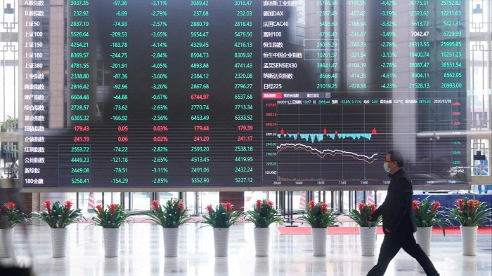 A man wearing a face mask inside the Shanghai Stock Exchange building at the Pudong financial district in Shanghai