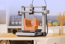 3D Printer On A Kitchen Counter Printing A Custom Pot Lid Organizer With A Modern Kitchen In The Bac Avif
