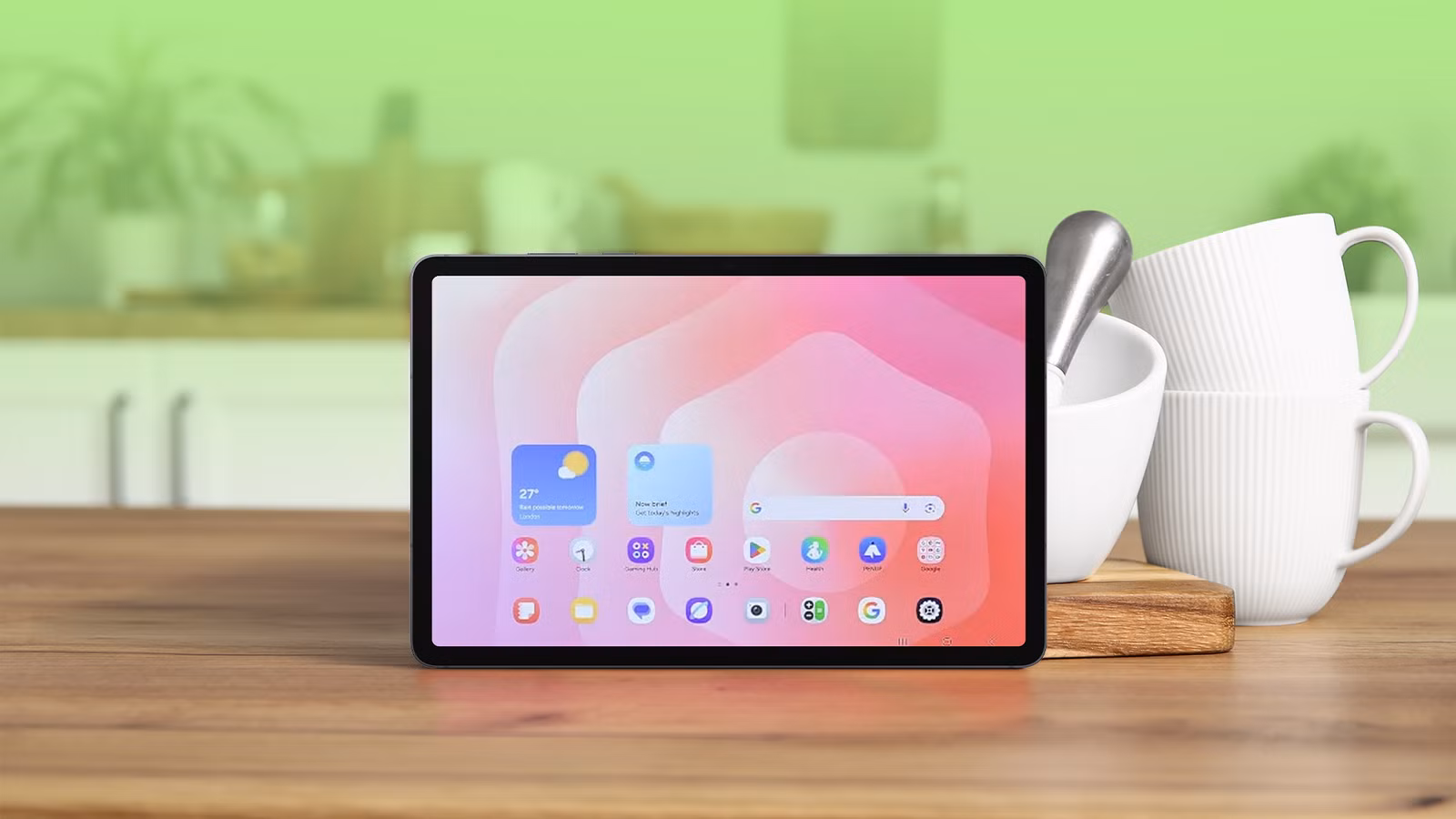 an android tablet on a wooden kitchen counter next to white ceramic cups and a pestle and mortar png