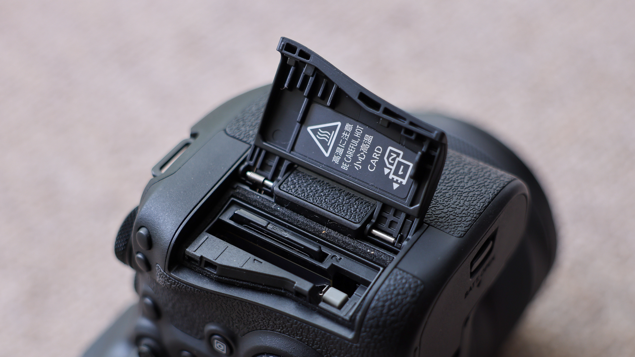 The CFexpress card and SD card slot on the Canon EOS R6 III.